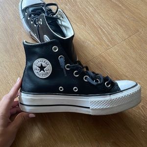 Black leather converse high tops.